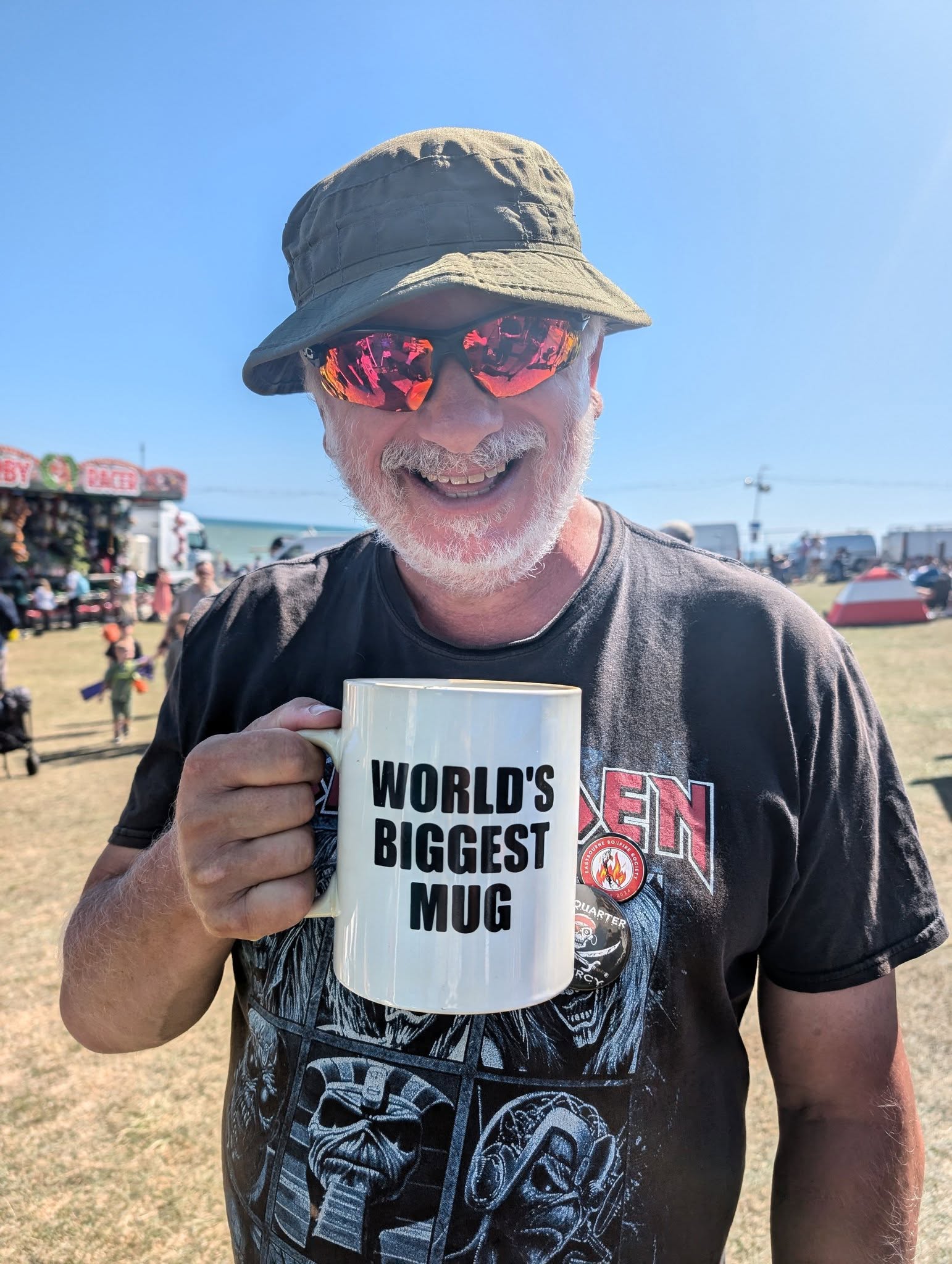 An EBS member holds a mug reading worlds biggest mug